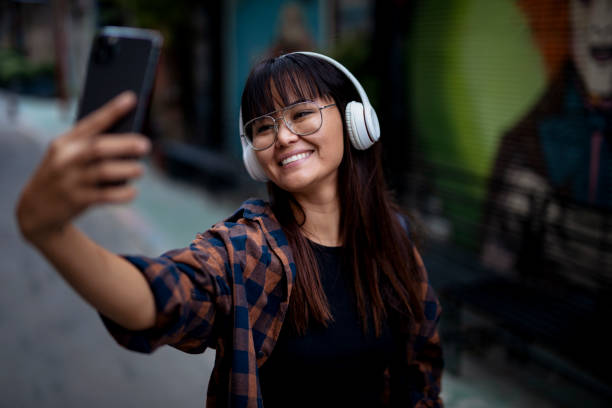 istock Smiling girl taking selfie photo 1425995849