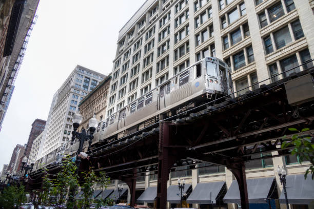 istock Silver train speeding on a track through a city 1426004074