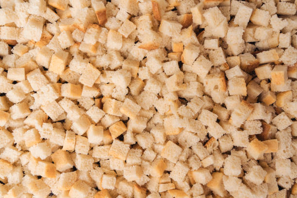 istock Bread cut into square slices for baking in the oven, top view. The process of making crackers 1426004127