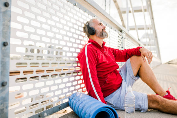 istock Senior man resting after jogging outdoors 1426004394