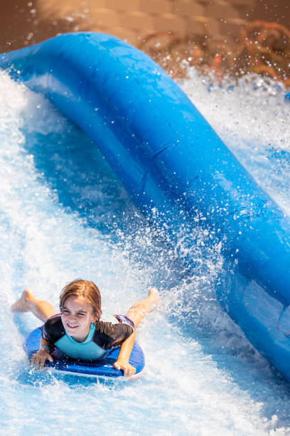 istock Young boy descends waterslide at speed 1426004807
