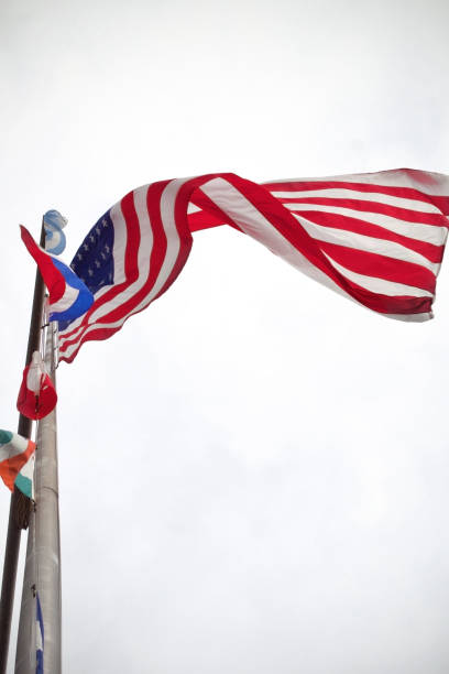 istock american flag on pole from below with white background 1426008251