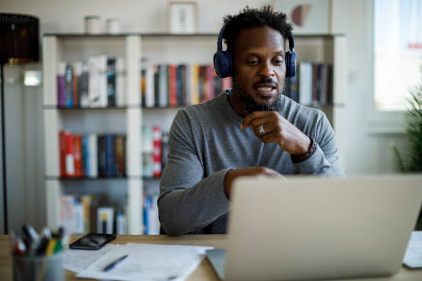 istock Man with headphones attends an online course at home 1426011954