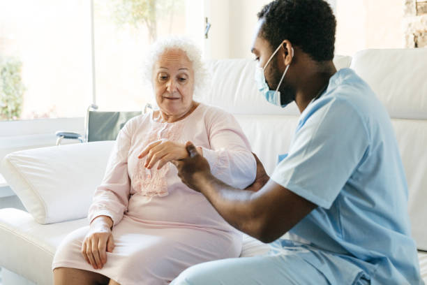 istock Senior woman getting physical therapy treatment at home 1426017891
