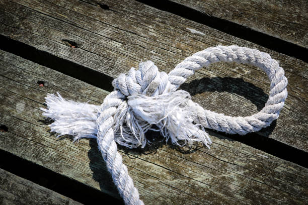 istock Nautical rope tied in a knot, laying a pier 1426020671