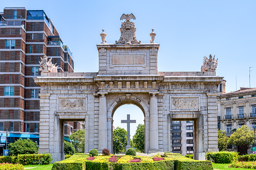 Valencia, Spain - September 19, 2019: Close-up of Triumphal Arch in Valencia, Spain. There is a cross at the center of the structure, and no people are in the scene.