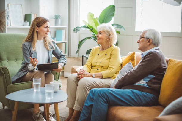 istock Senior couple consulting with female advisor 1426024275