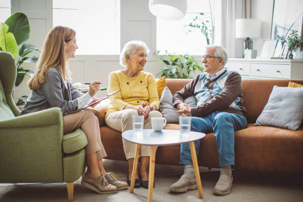 istock Senior couple consulting with female advisor 1426024356