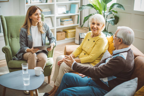istock Senior couple consulting with female advisor 1426024361