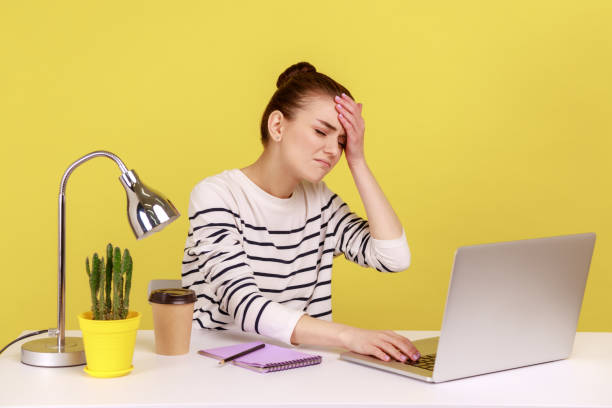istock Woman manager sitting at workplace with laptop and keeping hand on forehead, blaming herself. 1426024366
