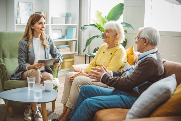 istock Senior couple consulting with female advisor 1426024371