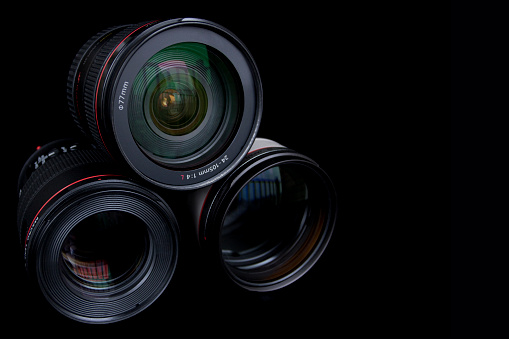 Professional DSLR Camera lenses on black background.