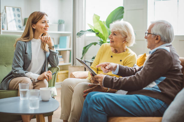 Senior couple consulting with female advisor