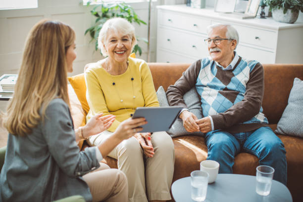 istock Senior couple consulting with female advisor 1426024437
