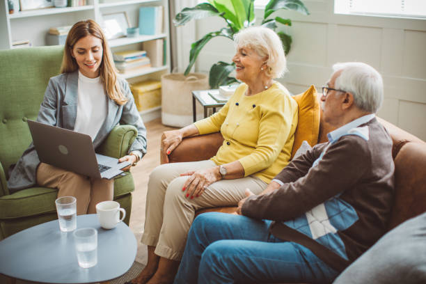 istock Senior couple consulting with female advisor 1426024442