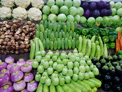 Vegetables arranged on stall for sale.