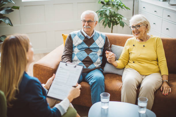 istock Senior couple consulting with female advisor 1426025784