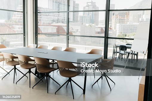 istock Empty boardroom office in urban city startup agency for business meeting, presentation and conference talk. Workshop room background, interior planning space and team training, seminar and convention 1426025819