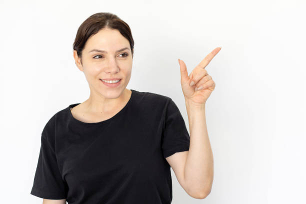 istock Cheerful woman pointing index finger at blank space 1426027334