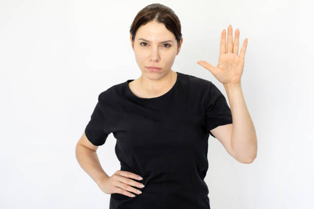 istock Serious Caucasian woman showing palm while looking at camera 1426027370