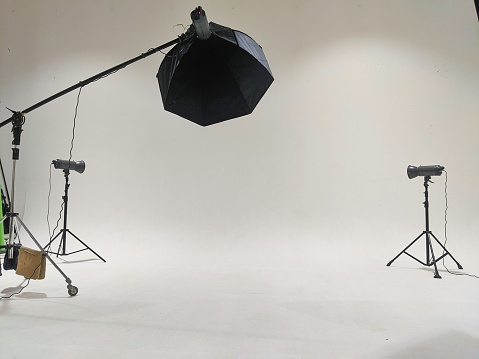 Inside view of photography studio with studio lights and white wall for background