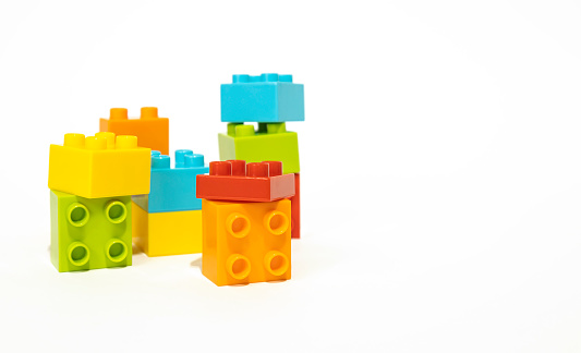 Multicolored plastic building blocks isolated on white background, children's toys, constructor