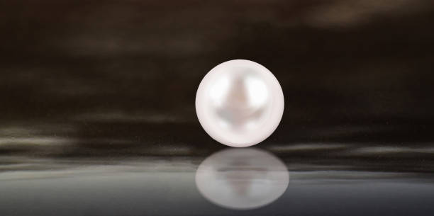 istock Real pearls Selected, beautiful color, laying on the ground, with reflection 1426043209
