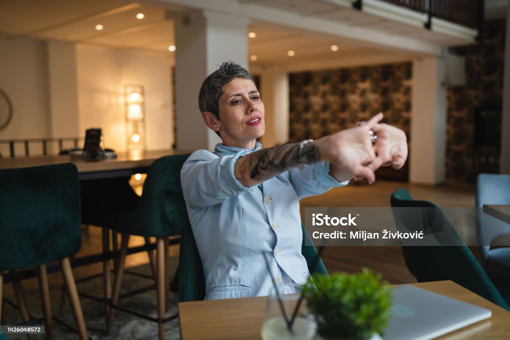One Woman Stretch Back And Arms At Cafe Taking A Brake From Work Stock  Photo - Download Image Now - iStock