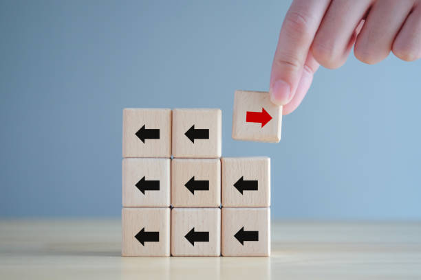 istock Hand holding red arrow that opposite direction black arrow. Individuality, Think outside the box, Think difference. Business disruption and leadership. 1426052018