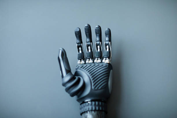 Human hand holding robotic hand