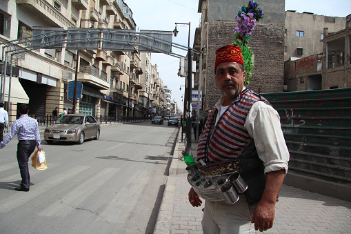 Aleppo, Syria - March 18, 2011: A man is seller on a sherbet stand in the street of Aleppo, syria.