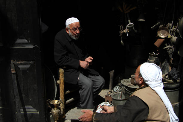 Aleppo, Syria - March 19, 2011: Men sitting in the streets of Aleppo.
