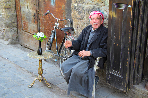 Aleppo, Syria - March 19, 2011: man sitting in the streets of Aleppo.