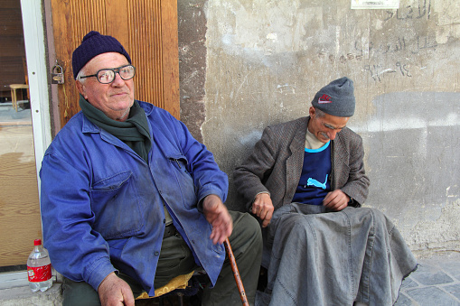 Aleppo, Syria - March 19, 2011: Men sitting in the streets of Aleppo.