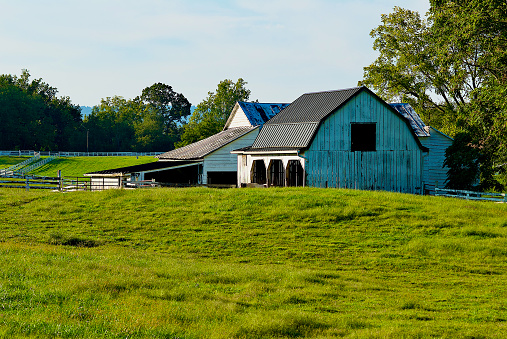 Traditional farmstead in the midwestern USA along a rural road with soybean fields
