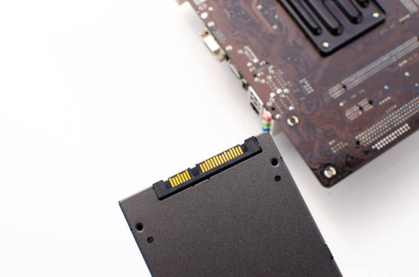 istock SSD High speed storage with computer motherboard on the side. Concept: technology, informatics, performance and innovation. White background and surface. SSD with port and golden connection. 1426069707