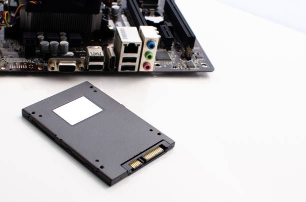 istock SSD High speed storage with computer motherboard on the side. Concept: technology, informatics, performance and innovation. White background and surface. SSD with port and golden connection. 1426069891