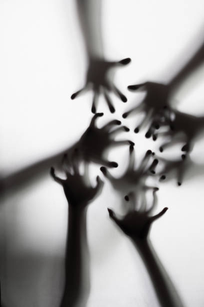 istock Shadow of a zombie hand on white background 1426070926