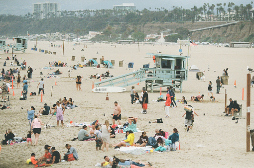 California, US; June 2019; Tourists on the beach next to Santa Monica Pier