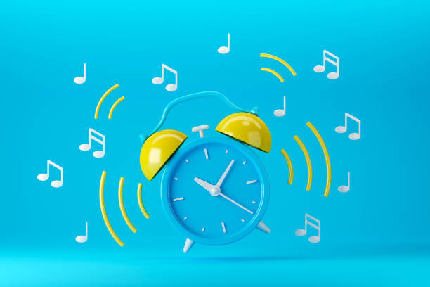 istock Blue and yellow retro ringing alarm clock with sound waves on blue background 1426076347