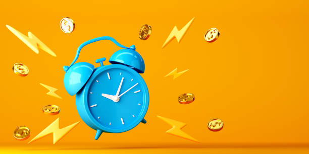 istock Blue alarm clock with floating gold coins around on bright yellow background 1426076410