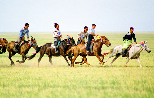 China has a large Mongolian population, mainly in the Inner Mongolia region bordering Mongolia. Naadam is the Mongolian annual most solemn national festival. There are horse racing, Mongolian wrestling, Mongolian chess, performances, rallies, trading and other traditional events. Film photo in 29 July 1997, Sonid Youqi,  Inner Mongolia, China