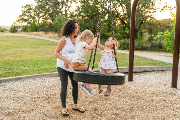 istock Toddler Friends Spinning On Park Tire Swing 1426078747