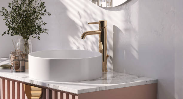 istock Modern and luxury pink bathroom vanity with marble counter top and white round ceramic washbasin in sunlight from window with vase of flower and scent sticks 1426087378