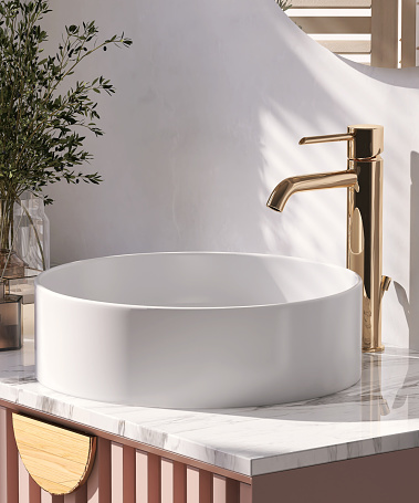 Modern and luxury pink bathroom vanity with marble counter top with white round ceramic washbasin and mirror in sunlight from window with vase of flower and scent sticks on white wall for product display