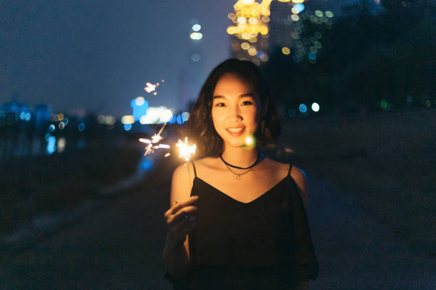 istock A woman having fun with a fireworks stick at night 1426095605