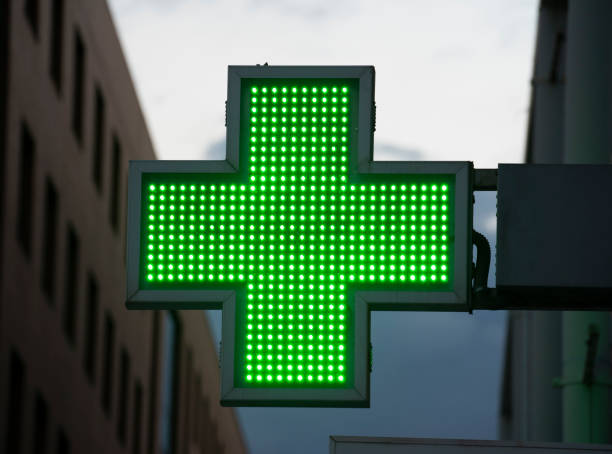 istock Pharmacy sign in Spain green neon attached to wall 1426097232