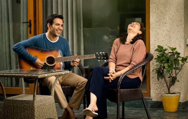istock Man playing guitar with his wife at home 1426101516
