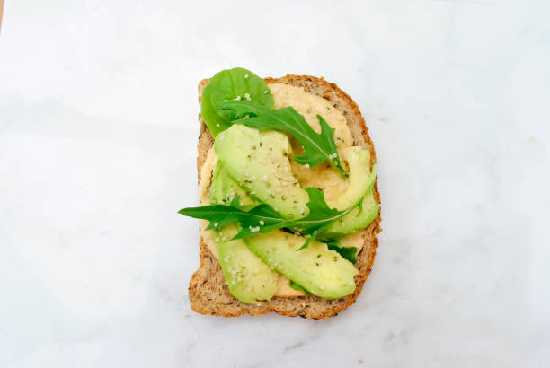 istock Whole Grain Bread with Hummus and Arugula 1426104923