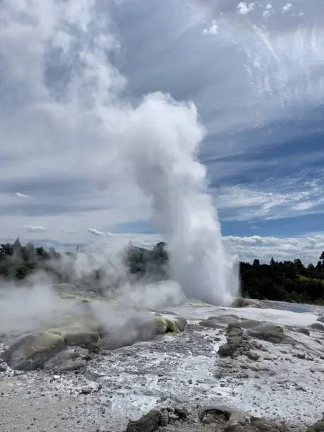 Photo of Geyser erupting into the sky at a geothermal park in Rotorua, New Zealand